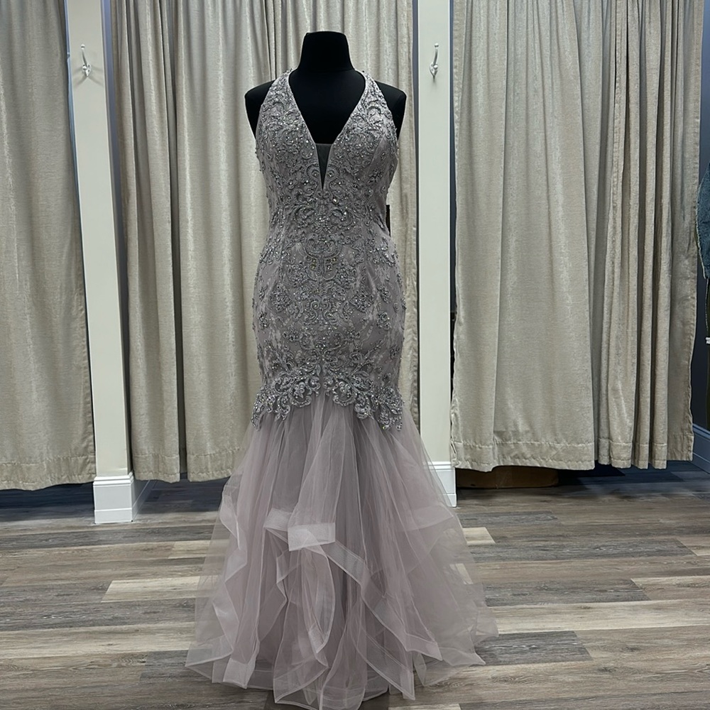This is a layered tulle trumpet mermaid gown. Size XL. Lavender. New with tags.